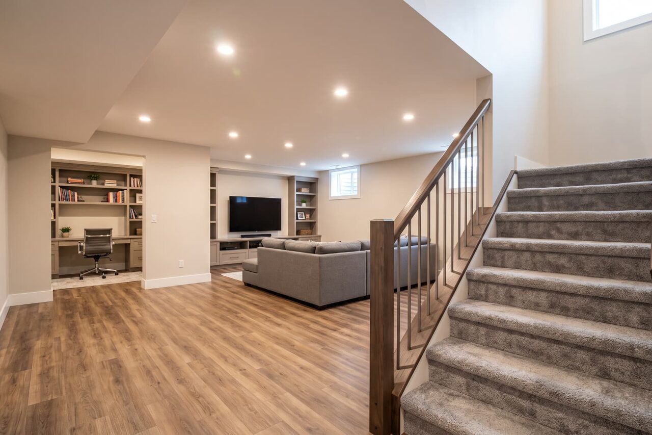 Open-concept finished basement living space and stairs in Calgary home